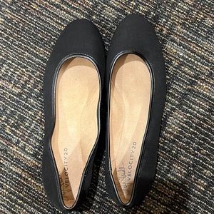 Black flats with silver accent on heel